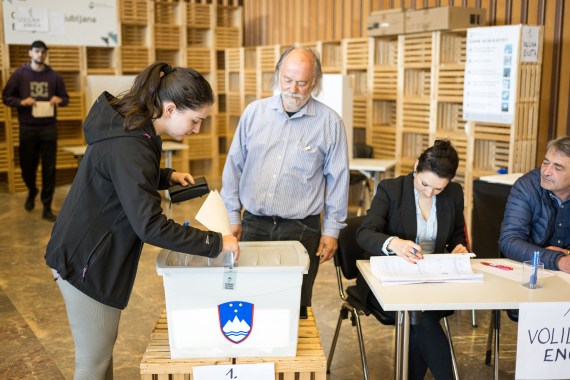 A woman casts her ballot at a polling station during a general election in Ljubljana on April 24