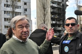 Antonio Guterres speaks to reporters in a street