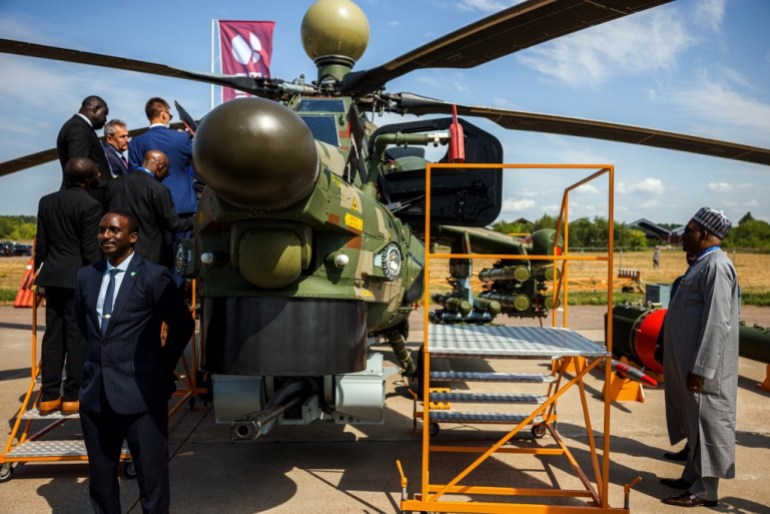 Members of a Nigerian delegation inspect a Russian Mil Mi-28NE Night Hunter military helicopter