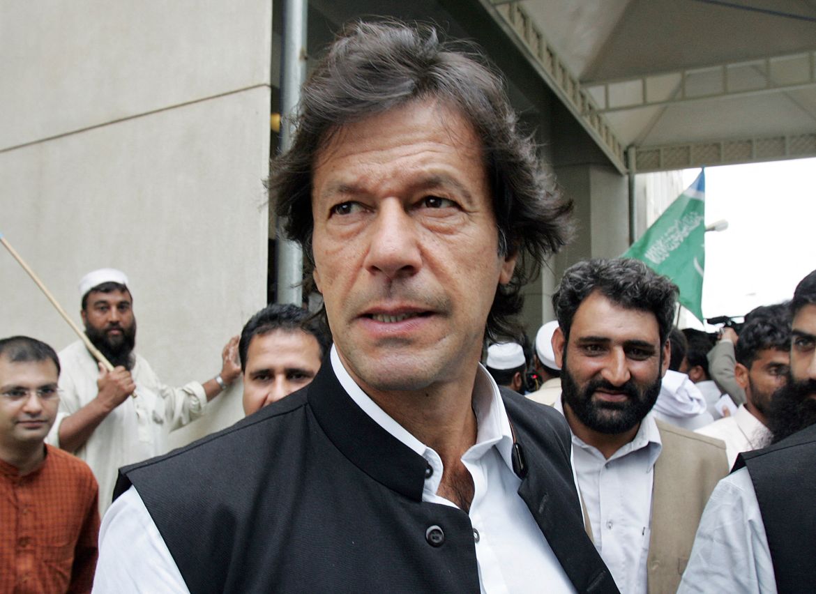 Pakistani cricketer-turned-politician Imran Khan (C) leaves the Supreme Court in Islamabad