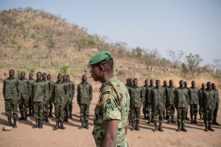 Rangers stand on attention on the parade ground during a graduation ceremony on January 12, 2018 at the Pendjari National Park training facility near Tanguieta