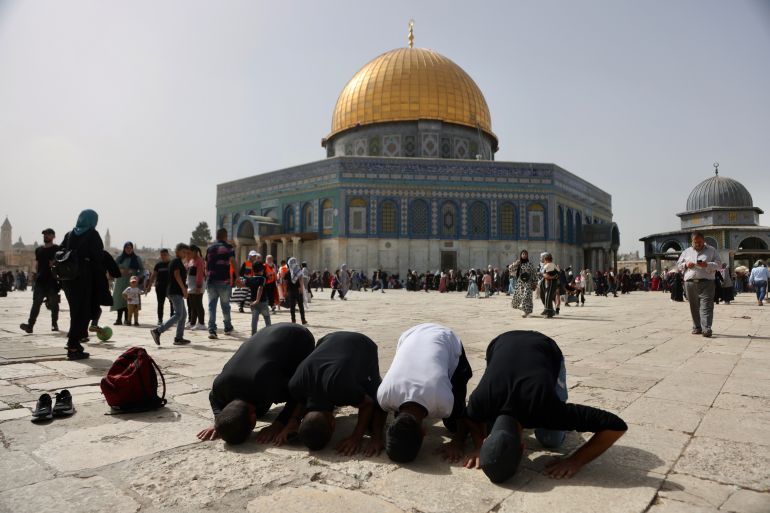 Palestinians pray in front of Al Aqsa mosque, occupied East Jerusalem