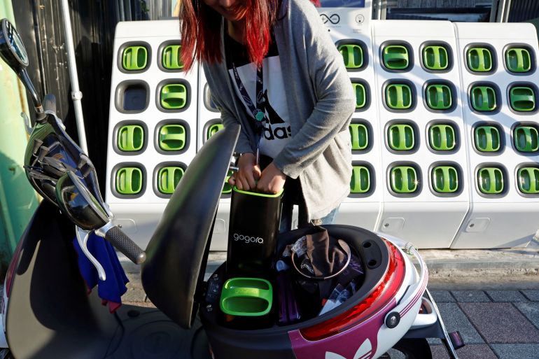 Woman charging Gogoro scooter