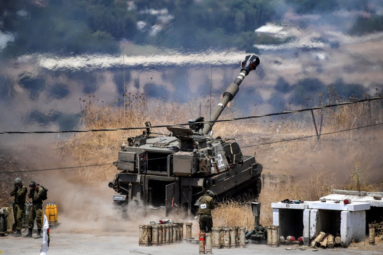 An Israeli artillery gun fires a shell into Lebanon on the Israeli side of the Israel-Lebanon border