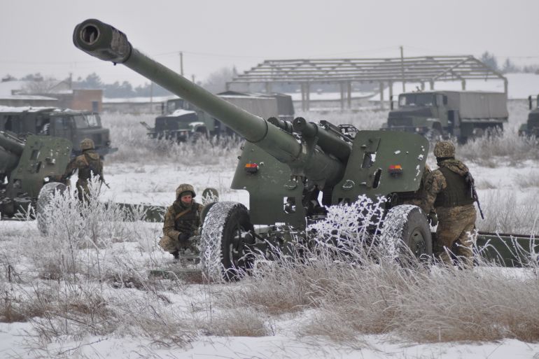 Ukrainian service members operate a 2A65 Msta-B howitzer during artillery and anti-aircraft drills near the border with Russian-annexed Crimea in the Kherson region, Ukraine, in this handout picture released January 28, 2022