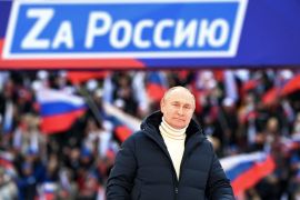 Russian President Vladimir Putin attends a concert marking the eighth anniversary of Russia's annexation of Crimea in Moscow in March 2022