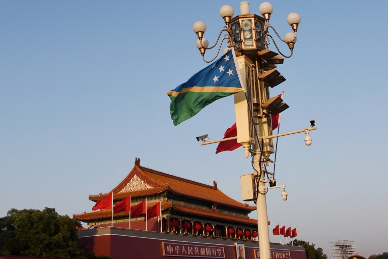 The national flags of Solomon Islands and China flutter at the Tiananmen Square in Beijing, China.