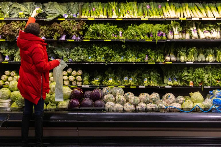 A person shops for vegetables at a supermarket in Manhattan, New York