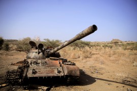 A destroyed tank is seen in a field in the aftermath of fighting between the Ethiopian National Defence Force (ENDF) and the Tigray People's Liberation Front (TPLF) forces in Kasagita town, in Afar region