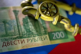 A model of the natural gas pipeline is placed on Russian rouble banknote and a flag in this illustration taken, March 23, 2022.