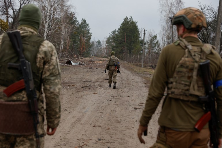 Ukrainian service members on patrol in the Kyiv region