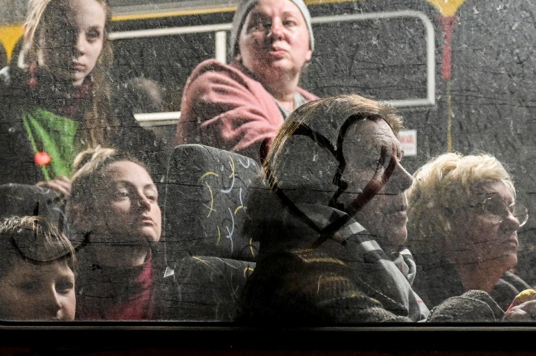 People who flee Mariupol and Melitopol as Russia’s attack on Ukraine continues, wait inside an evacuee bus at a collecting point in Zaporizhzhia, Ukraine April 1, 2022