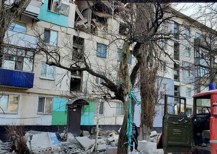 Rescuers evacuate a person from a residential building damaged by a military strike, as Russia's attack on Ukraine continues, is seen in Lysychansk, Luhansk region, Ukraine in this handout picture released March 30, 2022.