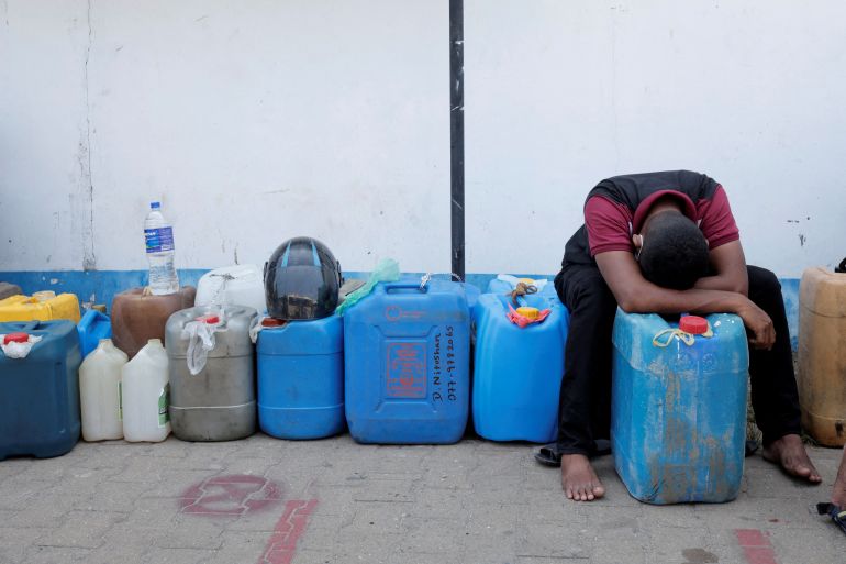 A man rests while waiting in a line to buy diesel near a Ceylon Petroleum Corporation fuel station, amid the country's economic crisis in Colombo