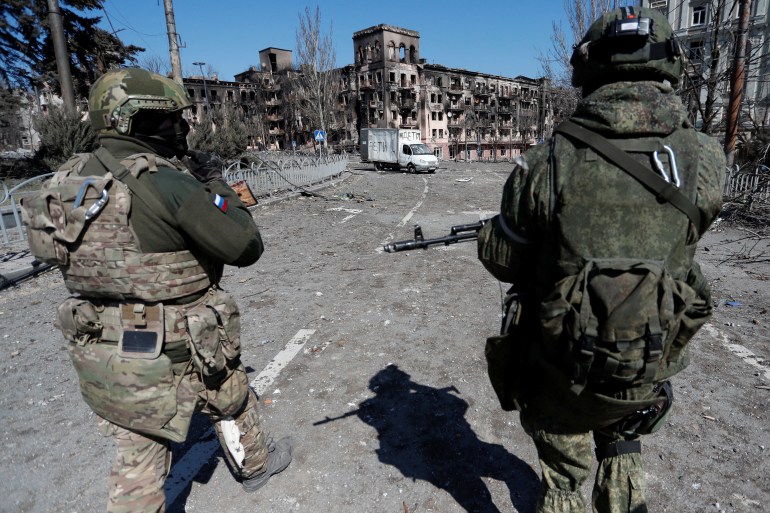 Service members of pro-Russian troops are seen in Mariupol