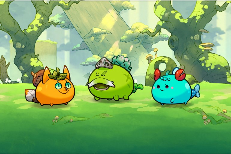 The blockchain-based game Axie Infinity with rotund orange, green and turquoise characters in a woodland scene