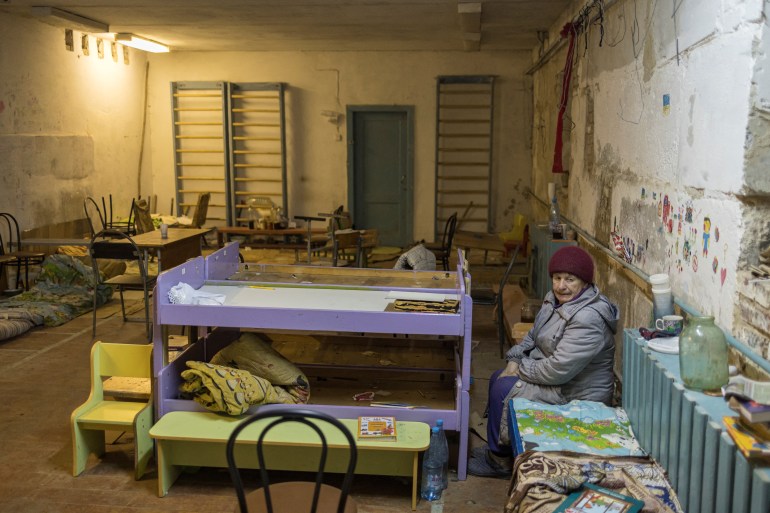 Tamara Klymchuk, 64, sits inside the basement of a school, as Russia's invasion of Ukraine continues, in the village of Yahidne