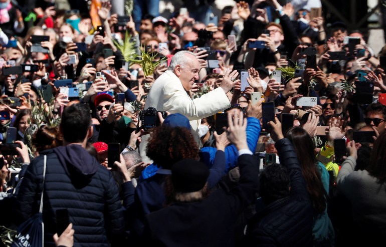 Pope Francis greet people after leading the Palm Sunday Mass in Saint Peter's Square at the Vatican