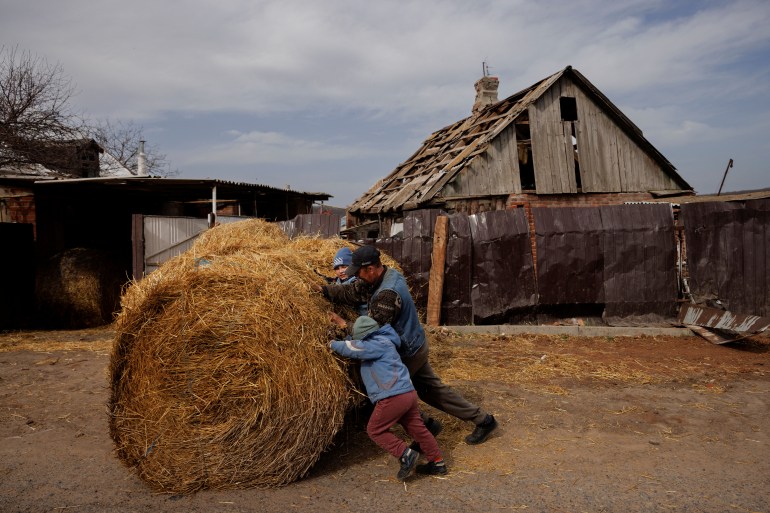 A father and son work in a farm in Yakovlivka, Ukraine.