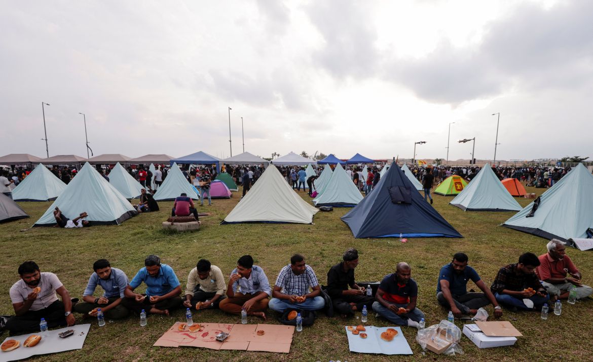 Muslim demonstrators eat Iftar meal inside a protest area