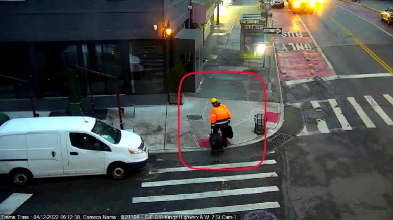 An image from a surveillance camera located at West 7th Street and Kings Highway in Brooklyn shows a man carrying a backpack in his right hand and dragging a rolling bag in his left hand, as he leaves the U-Haul Vehicle.