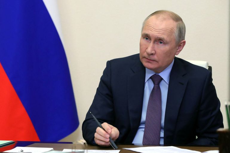 Vladimir Putin chairs a meeting by video link.