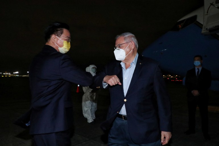 Bob Menendez, chairman of the U.S. Senate Foreign Relations Committee, greets Taiwan Foreign Minister Joseph Wu as he and other members of the U.S. delegation arrive at Taipei Songshan airport in Taipei,