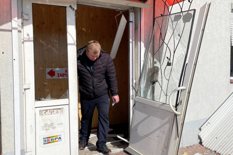 A man exits a building in Kyiv damaged by a Russian cruise missile strike