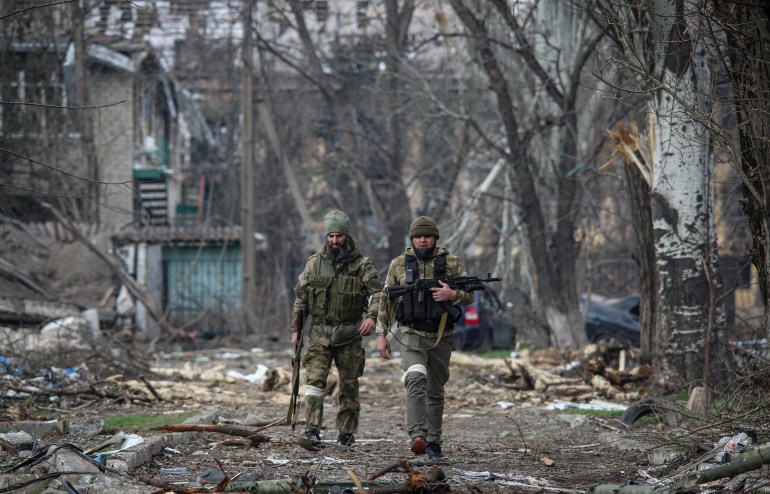 Service members from Chechen Republic walk during fighting in Ukraine-Russia conflict in the city of Mariupol, Ukraine April 15, 2022.