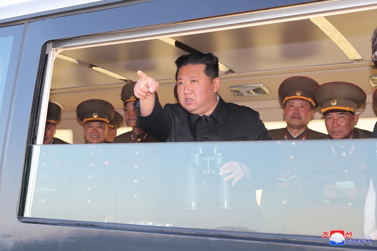 North Korean leader Kim Jong Un gestures as he watches the test-firing of a new-type tactical guided weapon according to state media,