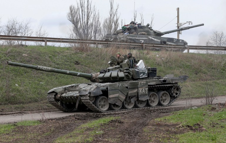 Service members of pro-Russian troops drive tanks during Ukraine-Russia conflict near the southern port city of Mariupol, Ukraine.
