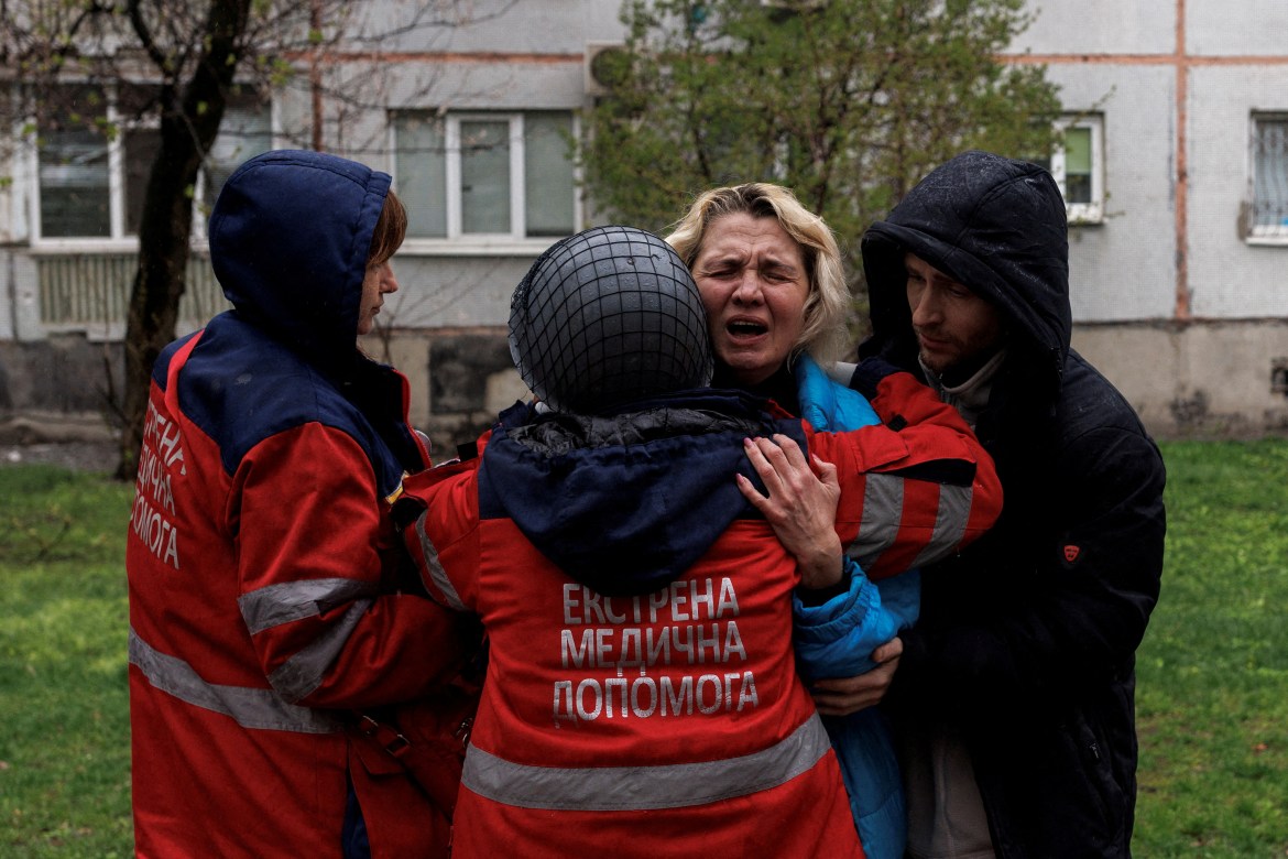 Yana Bachek mourns on the arms of a first responder