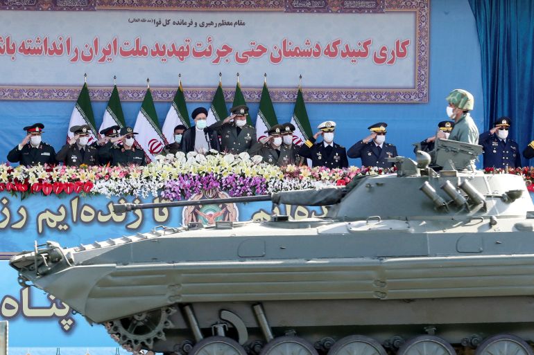 Iranian President Ebrahim Raisi and military commanders watch as military equipment passes by during a ceremony of the National Army Day parade in Tehran, Iran April 18, 2022.