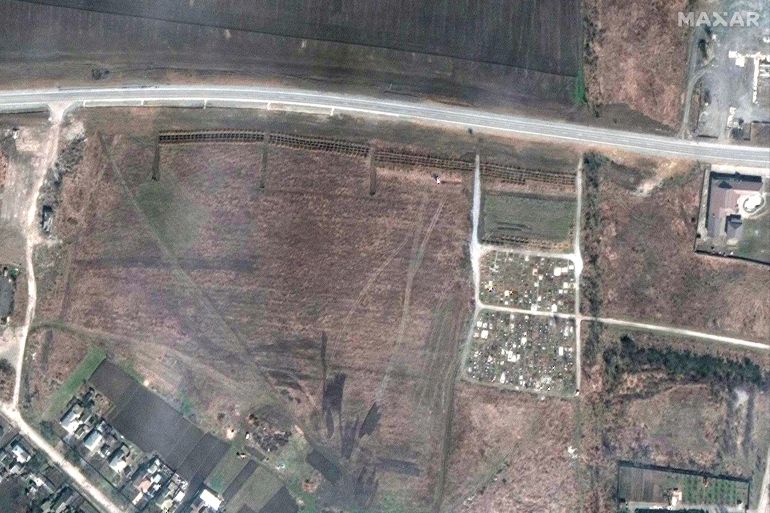 A satellite image shows an overview of a cemetery and the expansion of the new graves in Manhush, near Mariupol, Ukraine