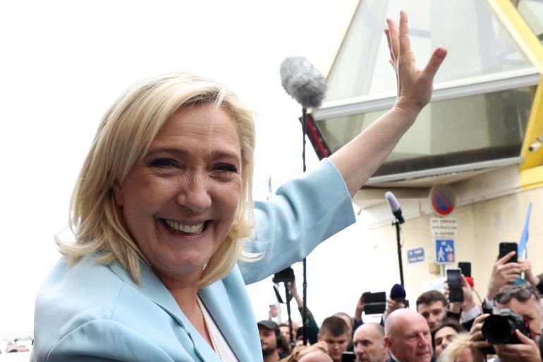 Marine Le Pen, French far-right National Rally (Rassemblement National) party candidate for the 2022 French presidential election, waves to supporters as she leaves after a visit in Berck-sur-Mer on the last day of campaigning, ahead of the second round of the presidential election.