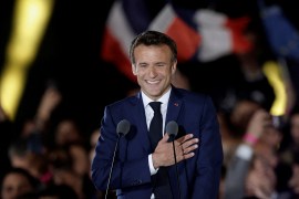 French President Emmanuel Macron gestures as he arrives to deliver a speech after being re-elected as president.