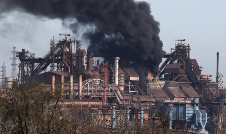 Smoke rises above a plant of Azovstal Iron and Steel Works 