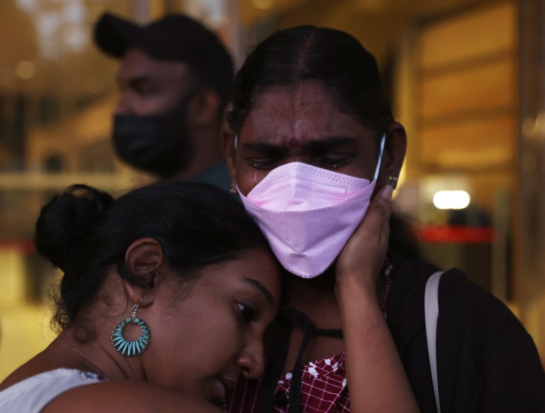 Nagaemthran's mother Panchalai Supermaniam, in a pink face mask, weeps as she thanks supporters after her failed last ditch court action on Tuesday