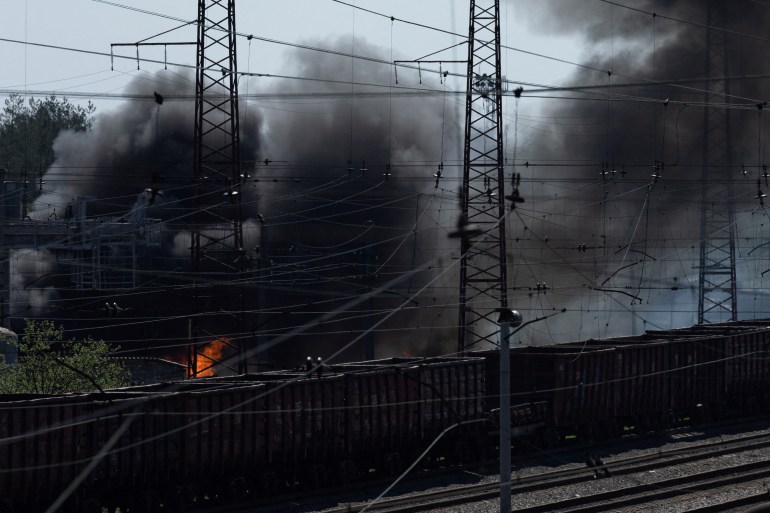 Smoke rises following a military strike on a facility near the railway station.
