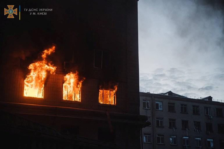 Fire burns in a building damaged by a missile strike, as Russia's attack on Ukraine continues, in Kyiv, Ukraine, in this handout picture released on April 29, 2022. 