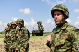 Serbian Army soldiers stand near the Chinese medium-range missile system FK-3, the latest weapon received by the Serbian Army on April 30, 2022 [Zorana Jevtic/Reuters]