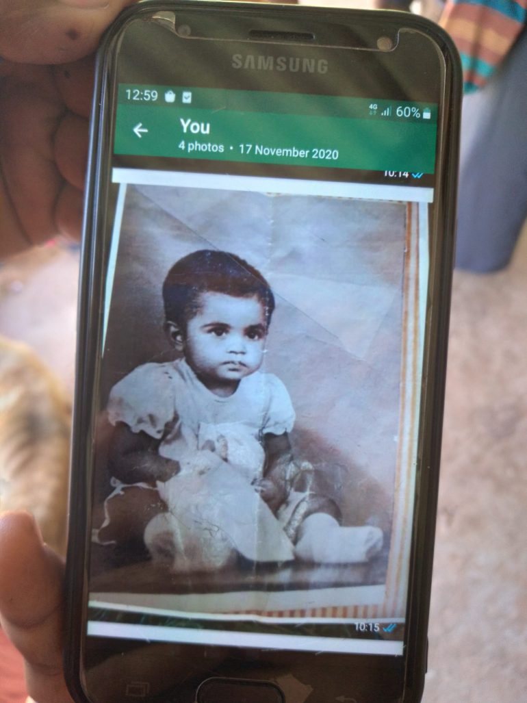 A photo of a child is shown on a smartphone