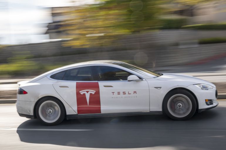 A Tesla car on a road.