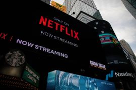 Netflix signage next to the Nasdaq MarketSite in New York, US