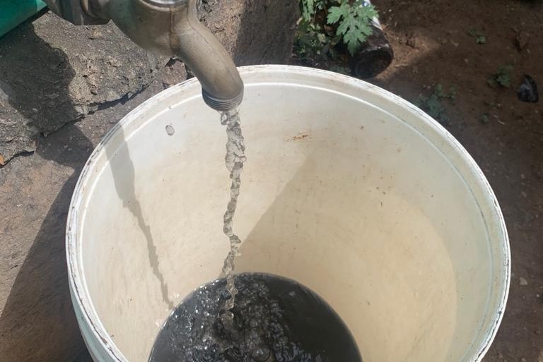 Black water flowing from a tap in Somkhele, a rural mining community in Kwa-Zulu Natal province, South Africa