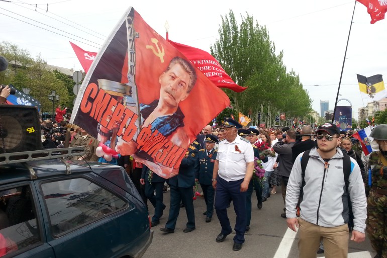 A pro-Russian rally in Donetsk, 2014. A flag with Soviet dictator Josef Stalin's portrait and a sing reading 'No to Fascism'