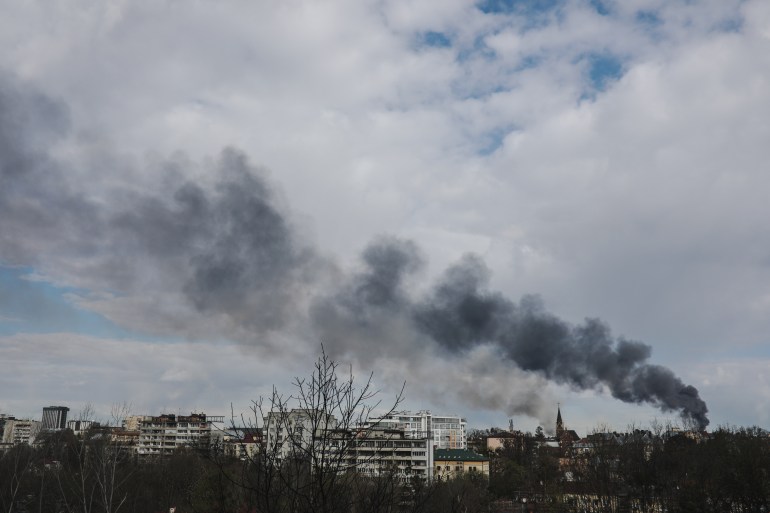 Smoke rises from buildings in Lviv reportedly after a Russian attack. 