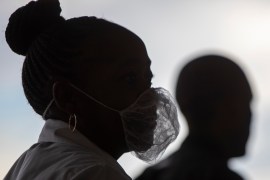 A woman wearing a disposable white beard mask, to protect against coronavirus