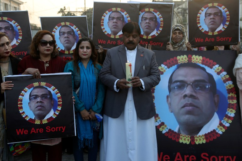 Members of a civil society group participate in a candlelight vigil to pay tribute to Sri Lankan factory manager Priyantha Kumara Diyawadana