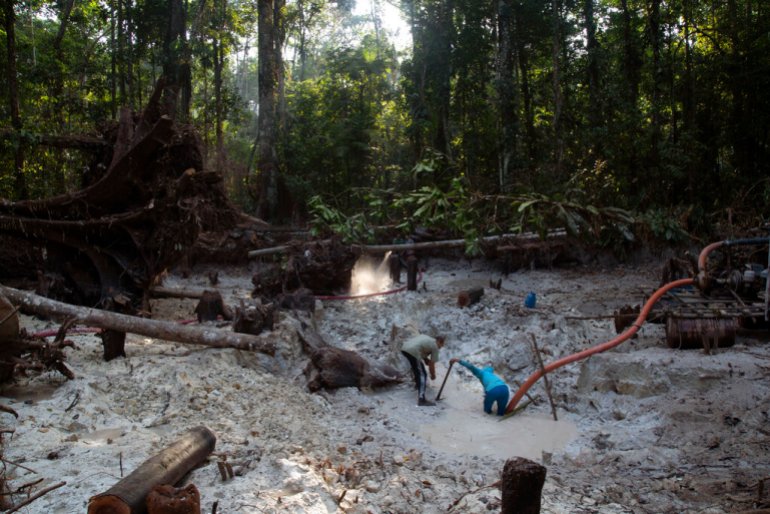 Men search for gold at an illegal gold mine in the Amazon jungle in the Itaituba area of Para state, Brazil.